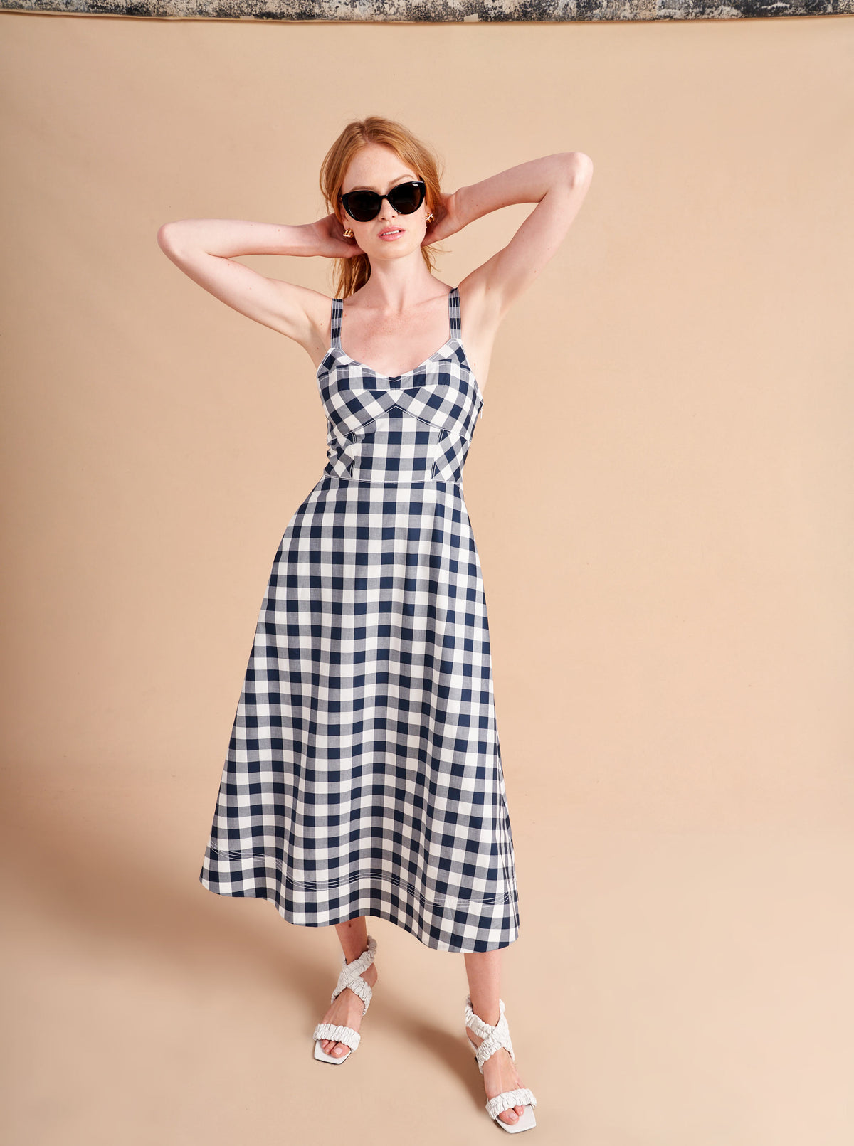 Retro meets modern in our stretch cotton, navy and white gingham, Fiona Dress with under bust seaming and full skirt. The smocked back panel ensures the perfect fit in this fit and flare must-have summer essential.