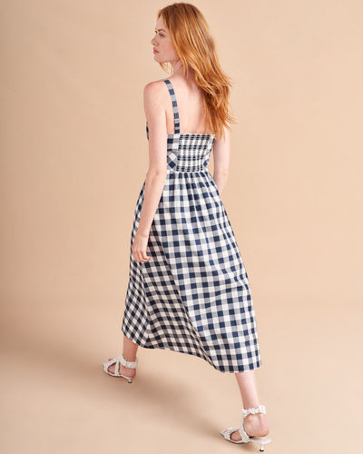 Retro meets modern in our stretch cotton, navy and white gingham, Fiona Dress with under bust seaming and full skirt. The smocked back panel ensures the perfect fit in this fit and flare must-have summer essential.