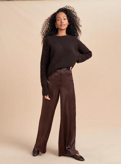 Understated luxury all wrapped up in this silky wide leg trouser in chocolate brown. Elegant enough to turn into a tuxedo by pairing it with a camisole or easy enough to wear with an oversize sweater, these high waisted trousers do the dressing up for you.