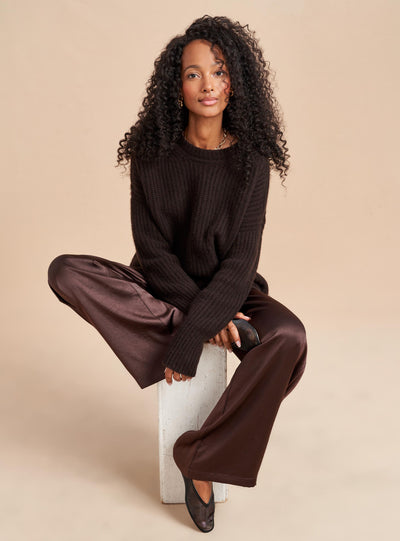 Understated luxury all wrapped up in this silky wide leg trouser in chocolate brown. Elegant enough to turn into a tuxedo by pairing it with a camisole or easy enough to wear with an oversize sweater, these high waisted trousers do the dressing up for you.