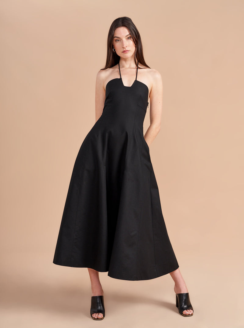 Some dresses are not meant to sit in your closet. This one will call your name so give in to the impulse, zip her up, and paint the town with this cotton stretch, halter neck, fit and flare frock. Dress up to get down. 