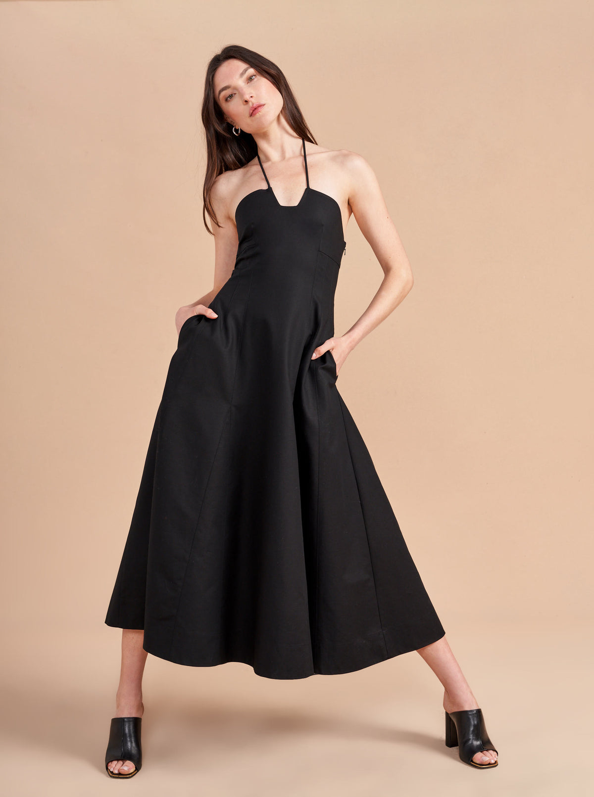 Some dresses are not meant to sit in your closet. This one will call your name so give in to the impulse, zip her up, and paint the town with this cotton stretch, halter neck, fit and flare frock. Dress up to get down. 