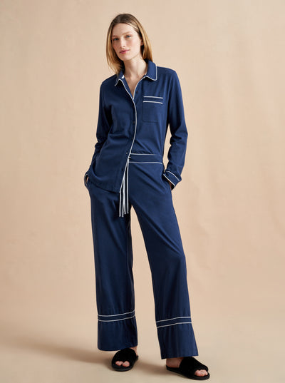 Pajama party ready. Our PJs are cut from our super soft t-shirt fabric for the ultimate in comfort and style when you need a little hygge. Navy cotton framed with contrasting white piping, our PJ set has a relaxed-fit top and elasticated drawstring wide-leg pants.