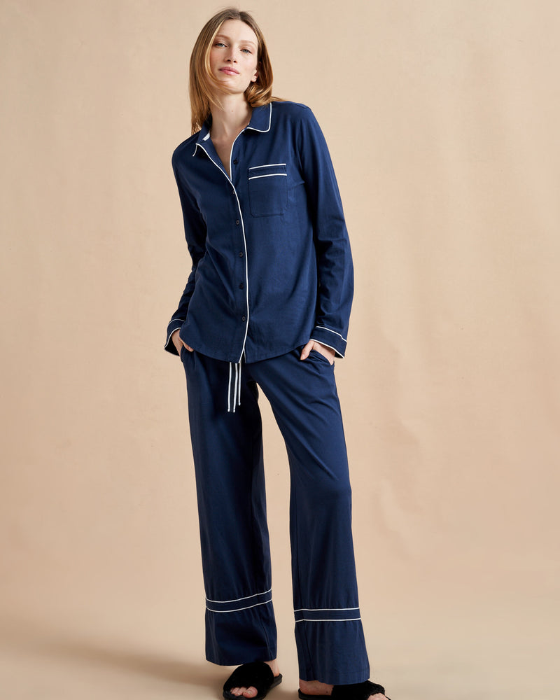 Pajama party ready. Our PJs are cut from our super soft t-shirt fabric for the ultimate in comfort and style when you need a little hygge. Navy cotton framed with contrasting white piping, our PJ set has a relaxed-fit top and elasticated drawstring wide-leg pants.