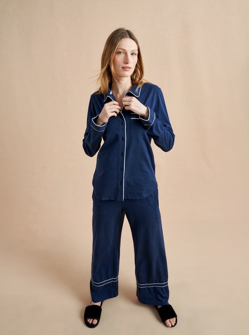 Pajama party ready. Our PJs are cut from our super soft t-shirt fabric for the ultimate in comfort and style when you need a little hygge. Navy cotton framed with contrasting white piping, our PJ set has a relaxed-fit top and elasticated drawstring wide-leg pants.