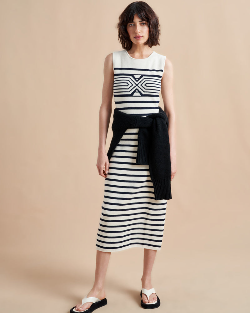 Is there anything better than a dress that does it all, from comfort, to style, to care? Meet Emmanuelle, our sleek, cotton stretch dress that slips over the head but still packs a punch on details. Made up of delicate ribbed stripes and an engineered striped design on the chest, this fitted dress with a touch of Lycra will hug you in all the right ways. Hand wash it at home and wear it again tomorrow.