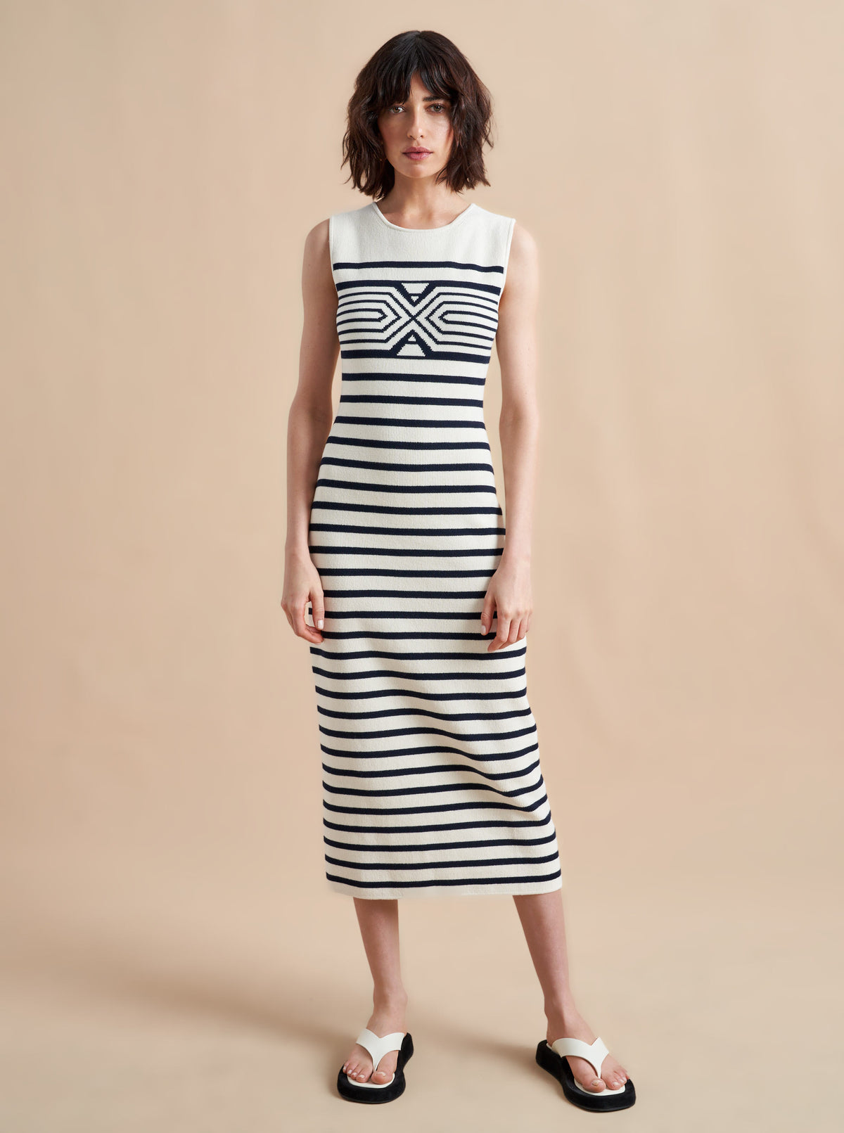 Is there anything better than a dress that does it all, from comfort, to style, to care? Meet Emmanuelle, our sleek, cotton stretch dress that slips over the head but still packs a punch on details. Made up of delicate ribbed stripes and an engineered striped design on the chest, this fitted dress with a touch of Lycra will hug you in all the right ways. Hand wash it at home and wear it again tomorrow.