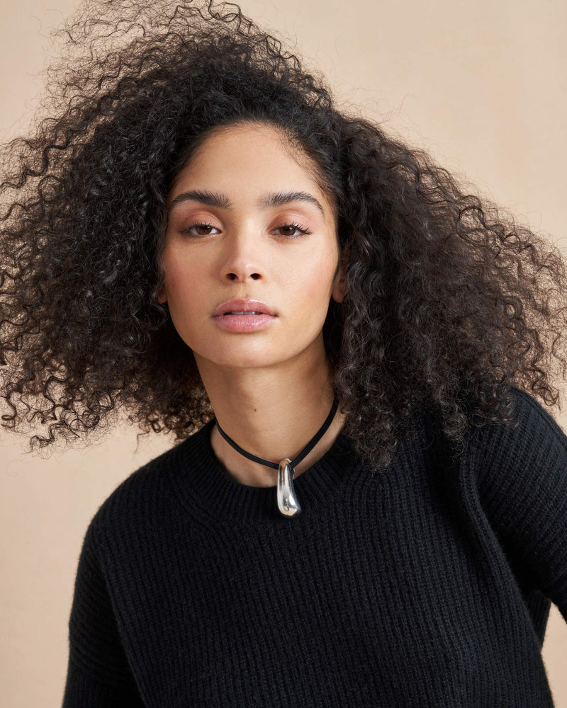 This is it. This is your everyday, never-without, take-with-you-everywhere sweater that will always have your back. Deliciously ribbed cashmere in a loose crewneck and slightly cropped silhouette means you need one in every color for tous les jours. 