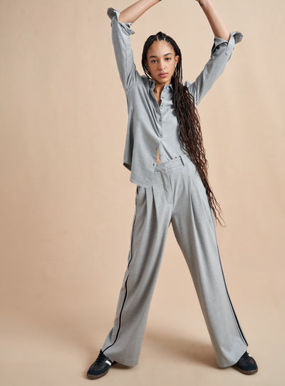 Inspired by La Bande member Selby Drummond, this grey, high waisted pleated trouser is elevated with a hint of sport. Feel free to run away with them in a flat boot or simply strut into a room when you wear them with heels. Just like Selby, there is nothing this pant can't do. 