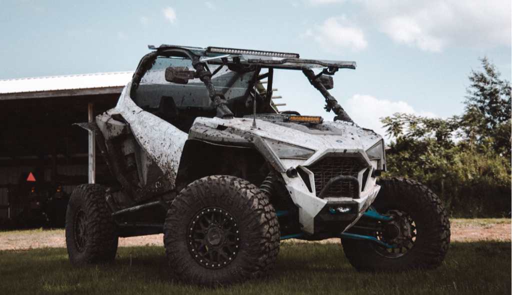 A Can-Am Commander parked in a field