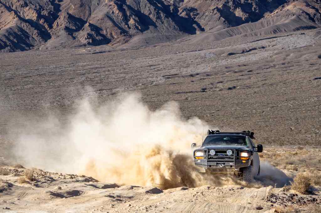 A black SUV on the sand