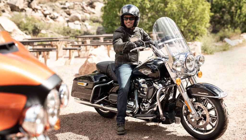 A man sitting on his Harley-Davidson Touring Motorcycle-1