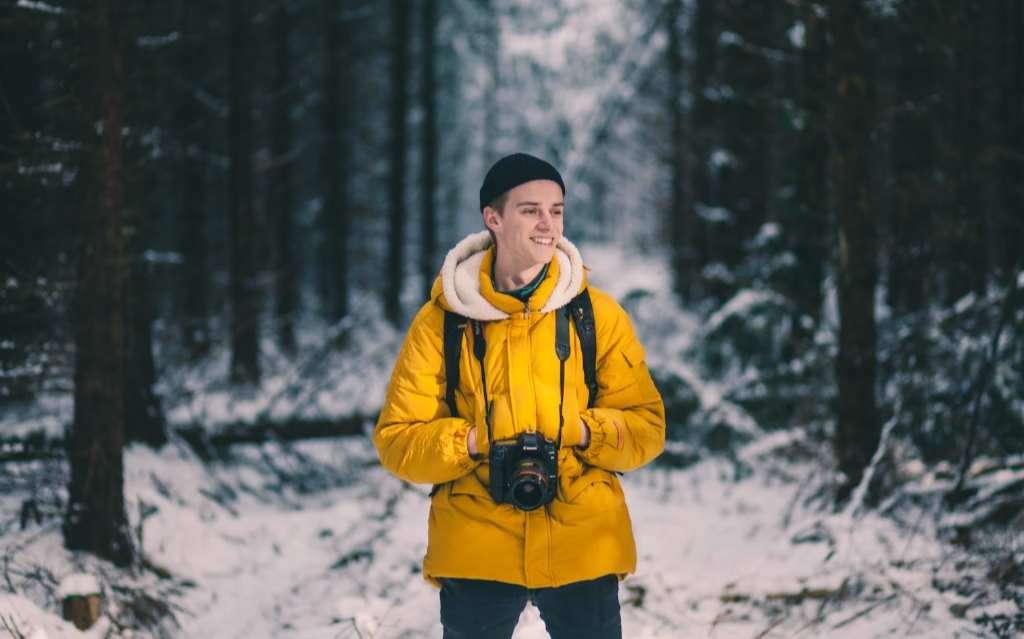 Man Standing With Jacket in the Snow