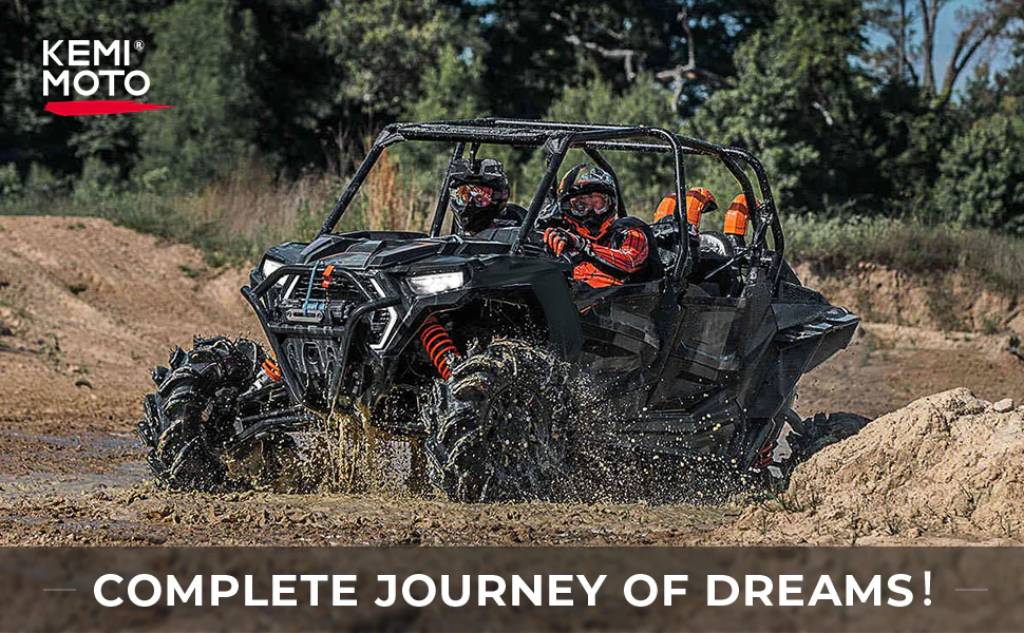 Men riding a UTV on a muddy road with the Kemimoto logo and the slogan Complete Journey of Dreams displayed