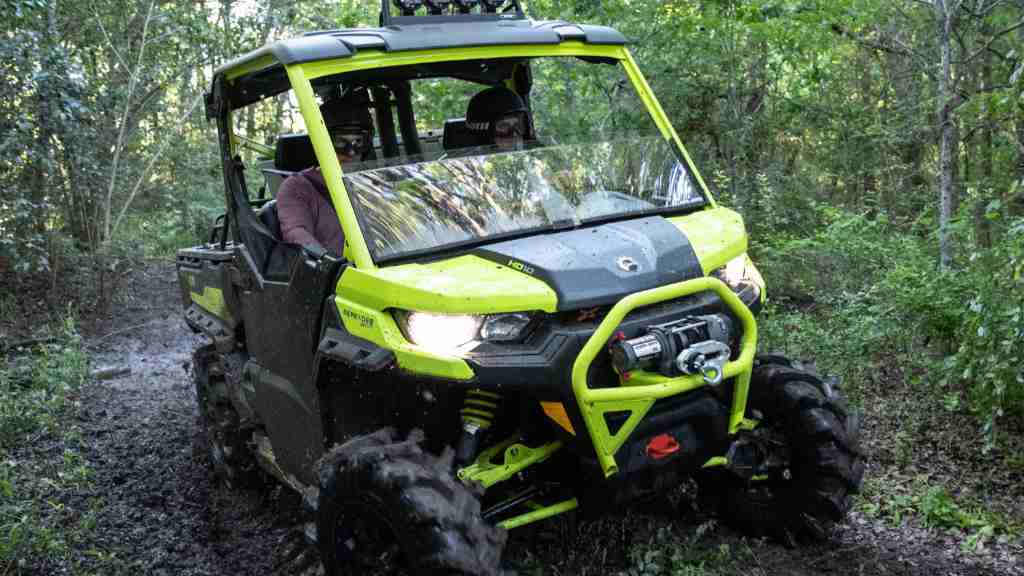 Riding a Can-Am Defender on a dirty and muddy trail