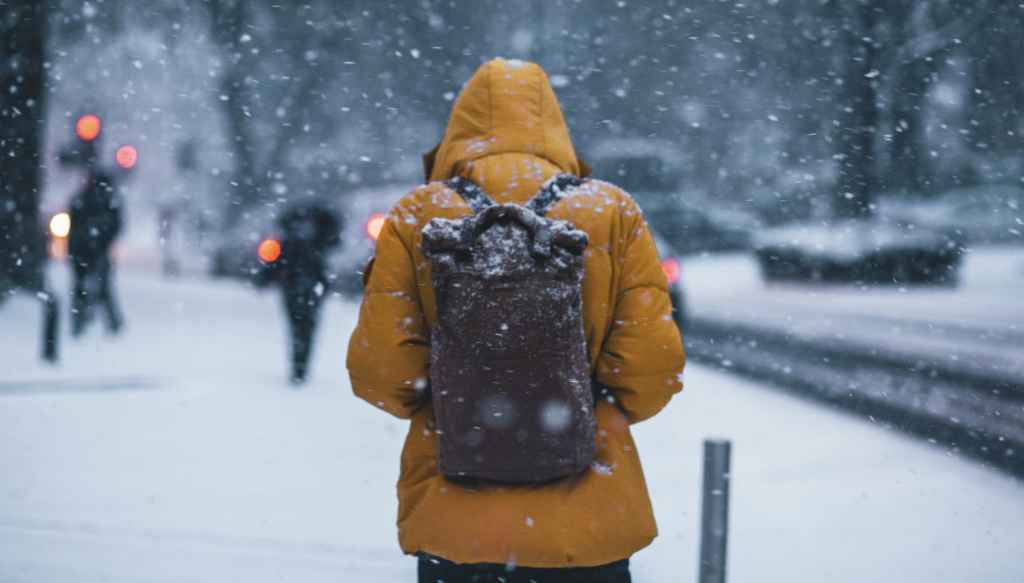 Standing in Snow with Backpack