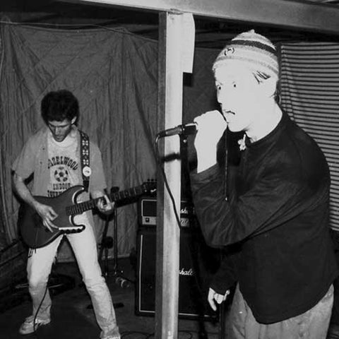 Jerry Morgenthaler and Kurt Hoffmann of Otto's Revenge playing a basement punk show in 1990.