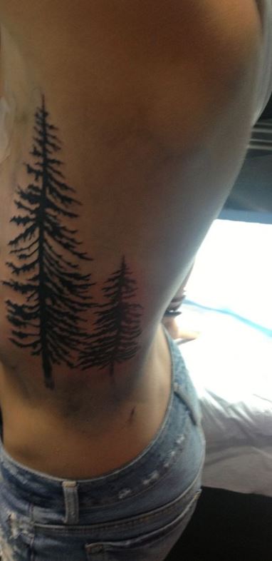 Pine tree tattoo on the right ribcage