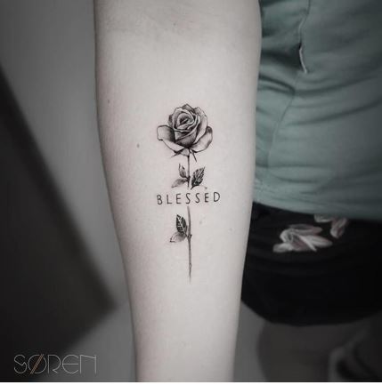 Love myself and rose tattooed on the inner forearm