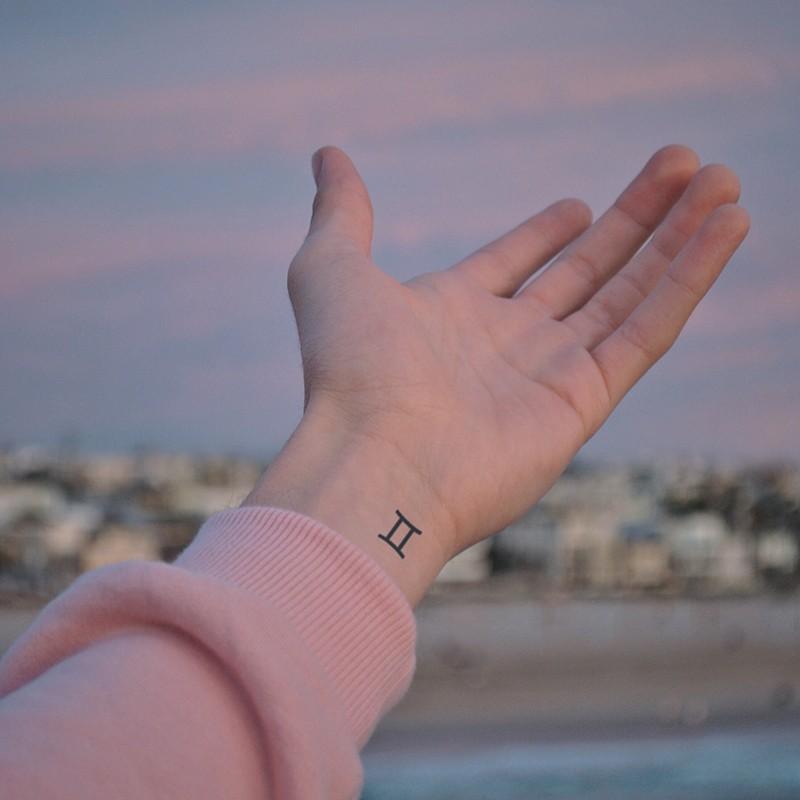 gemini symbol tattoo wrist