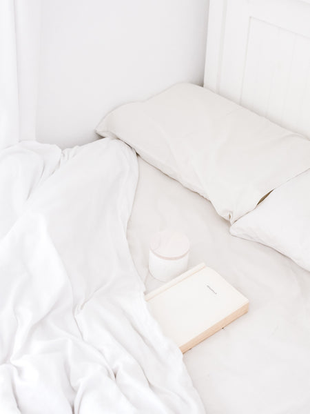 White Bedding on Mattress Portable Speaker
