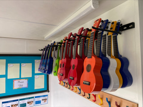 ukuleles stored on a wall in a school