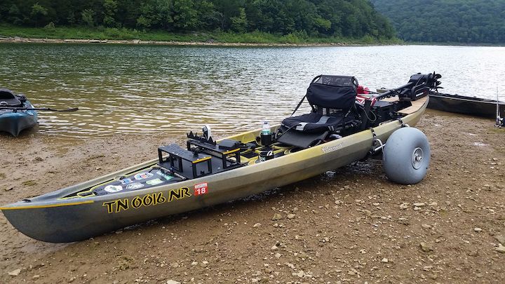 fishing kayak with "fishing "chariot" wheels ready to take it to the water