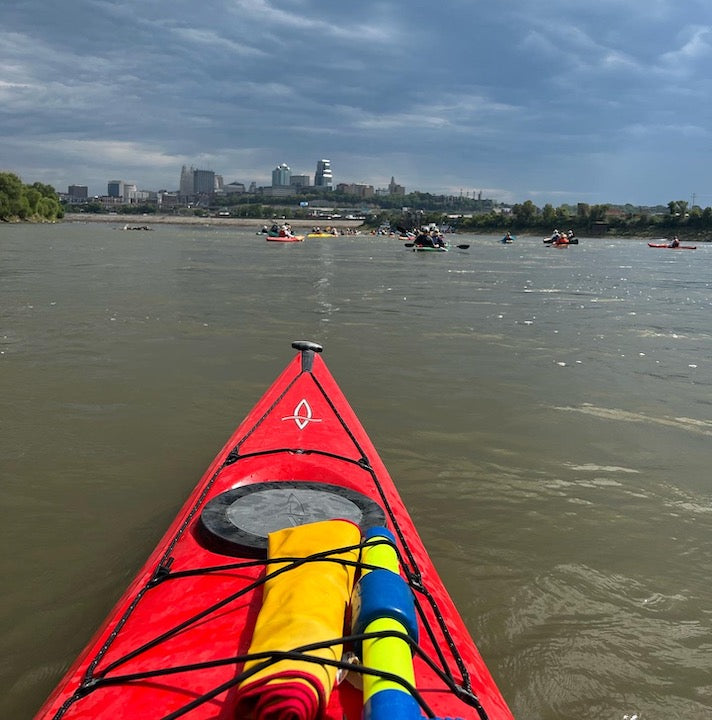 view from a kayak to a pack of kayakers on the Missouri River near Kansas City, MO