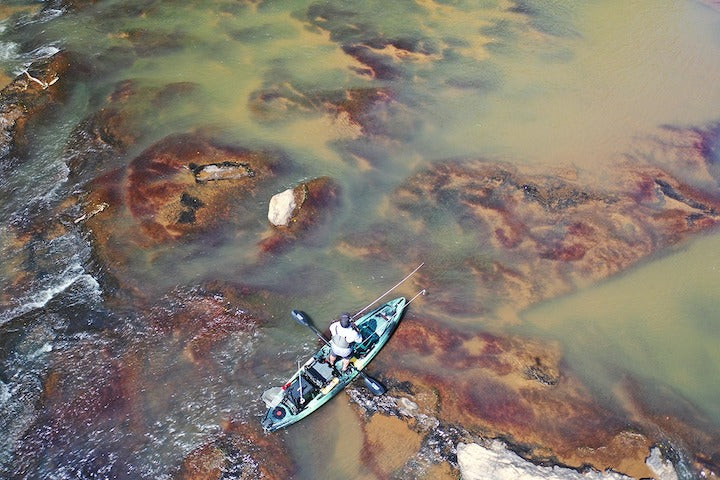 overhead shot of a kayak angler fishing on a river