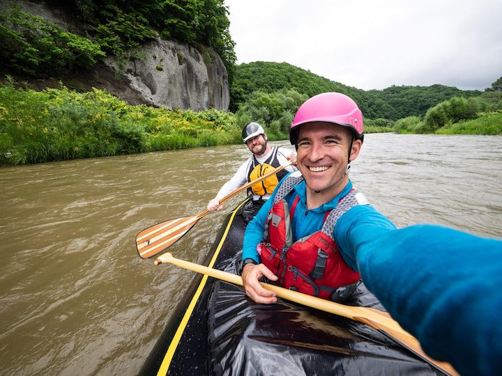 two men canoeing on a river