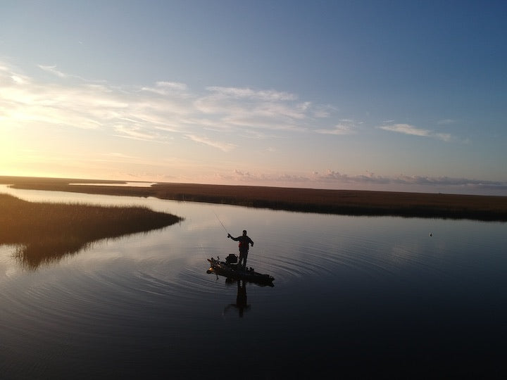 kayak angler at Bayou Cumbest, Mississippi, at sunset