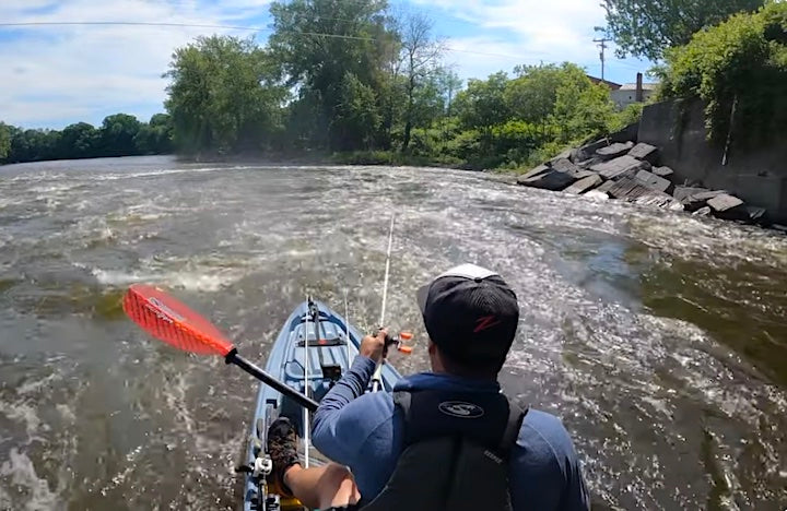 Drew Gregory kayak fishes in swift water