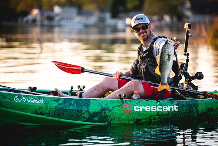 Drew Gregory in a fishing kayak with a nice fish