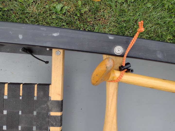 Bungee Dealee Bob ties extra paddle to canoe