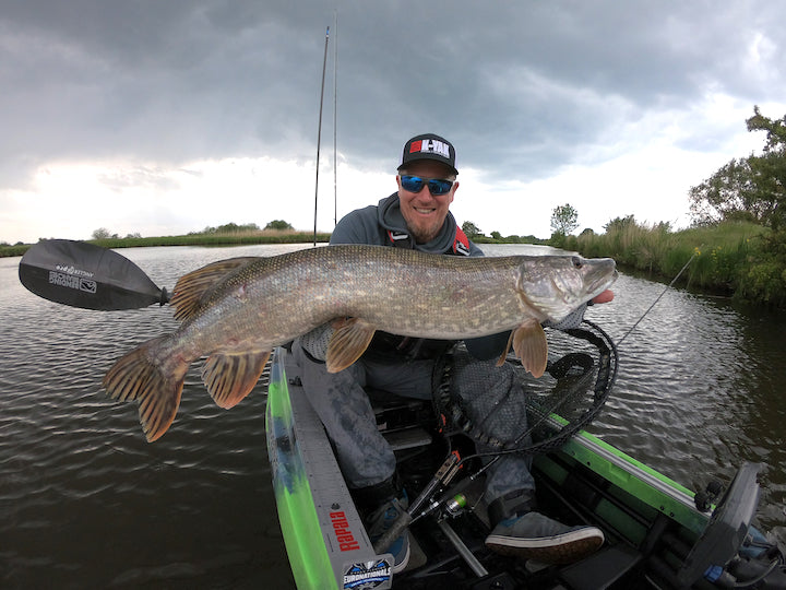 Dennis Kieselhorst in his fishing kayak with a huge pike