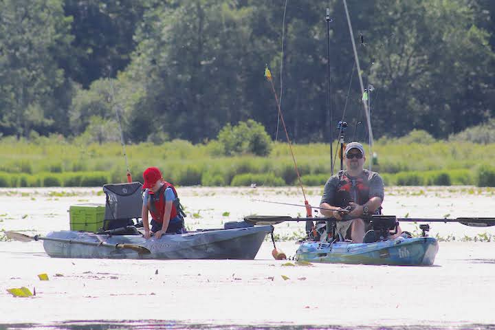 Tyler Thiede and his son Jackson kayak fishing