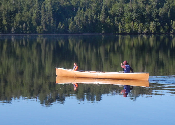 two young boys in a canoe together