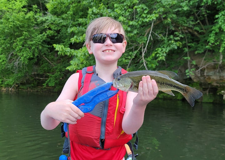 Jackson Thiede with a bass he caught kayak fishing