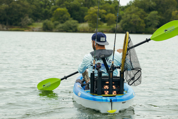man paddling a fishing kayak