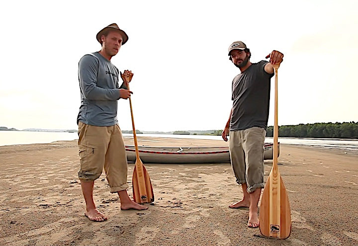 The Okee Dokee Brothers with Bending Branches paddles and their canoe on a sand spit
