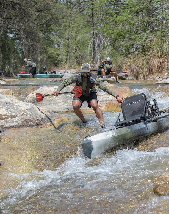 Terrell walks his kayak down a stretch or rapids