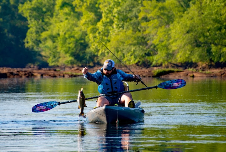 kayak angler pulls up a fish