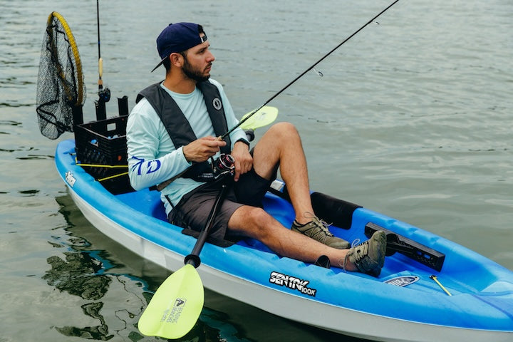 man fishes from a kayak