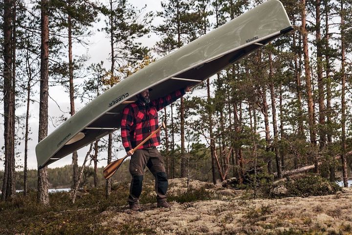Martin Trahan portages a canoe with his Bending Branches paddle