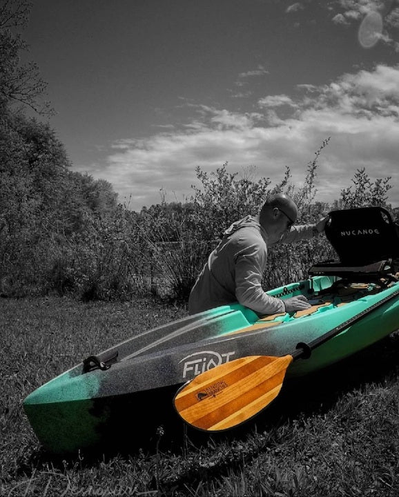 colorized photo of JD Desrosiers with his fishing kayak and Navigator paddle