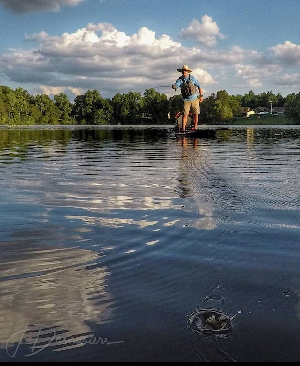 close up of lure hitting the water, kayak anglers in the background