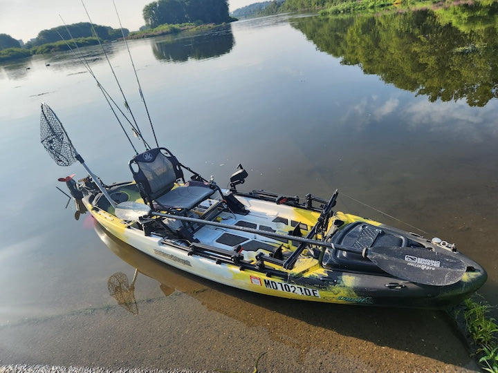 rigged out fishing kayak along shore