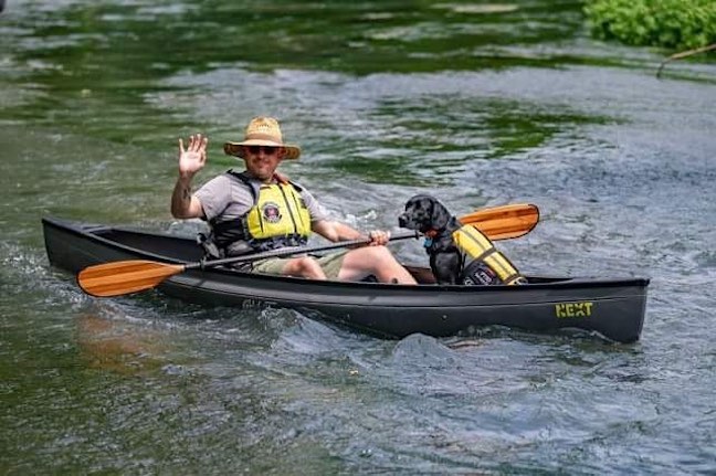 solo canoeist with his dog