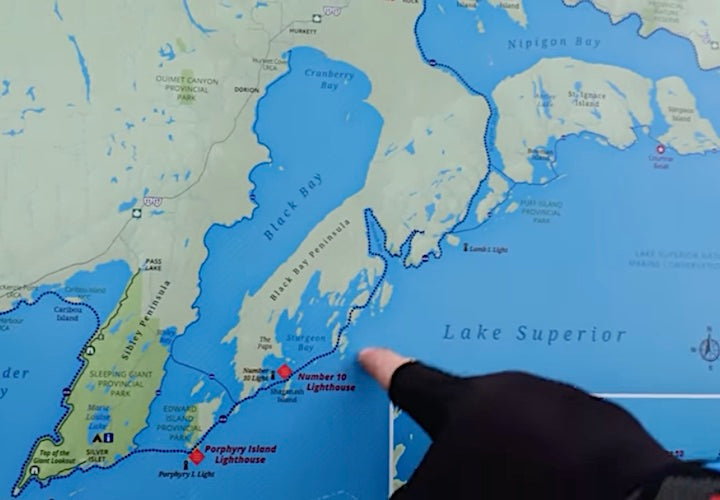 finger points to a map of the canoe route