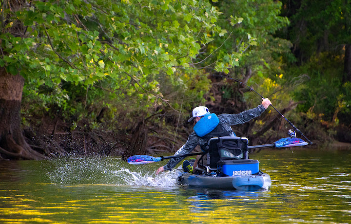 kayak angler pulls in a fish